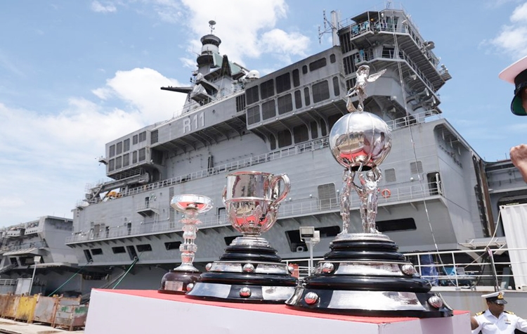 Flight deck of India's indigenous aircraft carrier INS Vikrant today hosted three magnificent Durand Cup Trophies